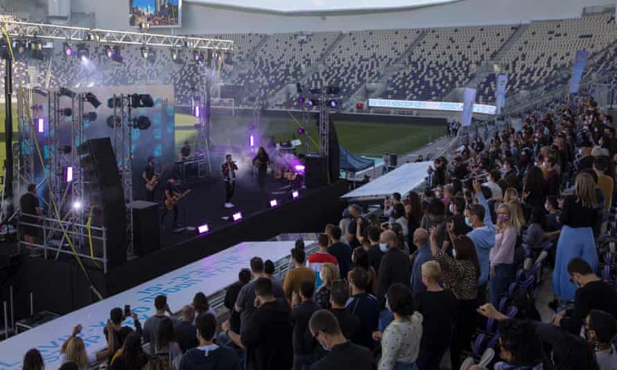 Israeli musician Ivri Lider performs in front of an audience wearing protective face masks