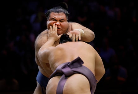 Tobizaru sticks a finger up the nose of Takayasu but Takayasu goes on to win the bout during the final day of the Grand Sumo tournament at the Royal Albert Hall.