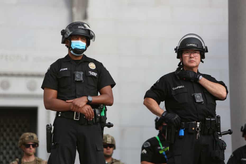 Police keep a watchful eye on a peaceful Black Lives Matter protest outside Los Angeles’ city hall on 2 June 2020.
