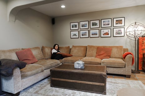 Woman sits in corner of large L-shaped couch