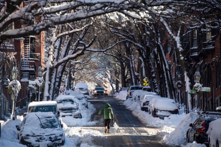 a person carries a shovel in the middle of a street