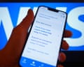 A person views the NHS app on a mobile phone.