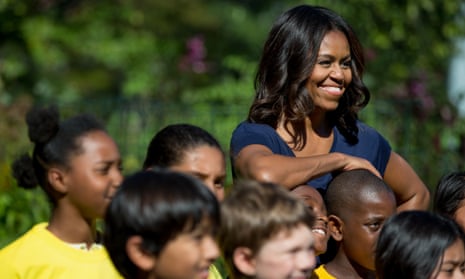 Michelle Obama with school children at the White House kitchen garden. As first lady she promoted healthier eating for kids. 
