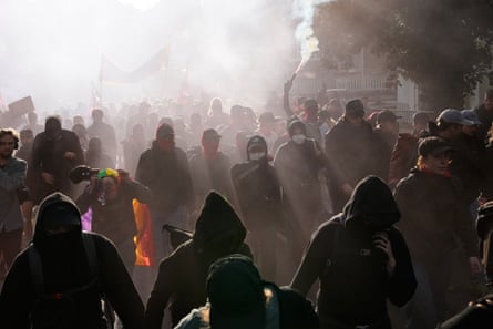Smoke surrounding protesters on the street