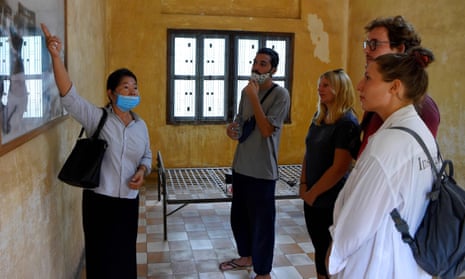A tour guide shows tourists around the recently reopened Tuol Sleng genocide museum in Phnom Penh 