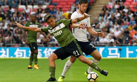 Ben Davies, right, challenges for the ball with Juventus’s Paulo Dybala.