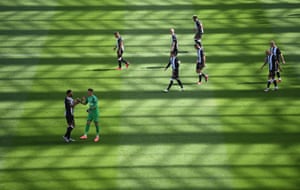 Newcastle United’s players walk out onto the pitch for the second half.