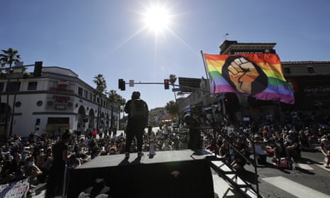 A speaker addresses the crowd from a stage on Sunset Boulevard .