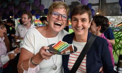 A couple pose with a slice of wedding cake at an event following the referendum on same-sex marriage, Bern, Switzerland.