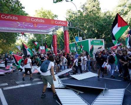Barriers are smashed by pro Palestine protesters at the finish line of the final stage in Madrid.