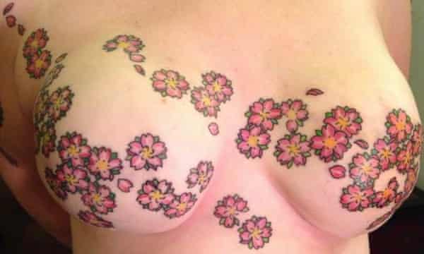 Breasts tattooed with a cherry blossom pattern