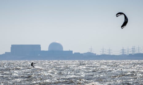 A kite surfer sails in front of the Sizewell B nuclear power plant on the Suffolk coast