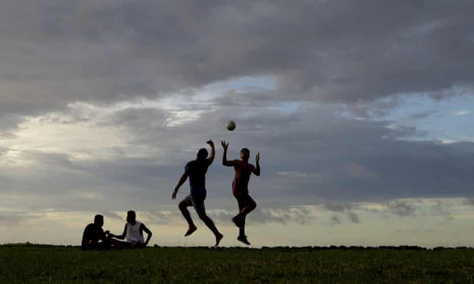 Young men play a game of rugby at sunset in Nuku’alofa, Tonga. The largest cluster of places without the coronavirus can be found in the scattered islands of the South Pacific