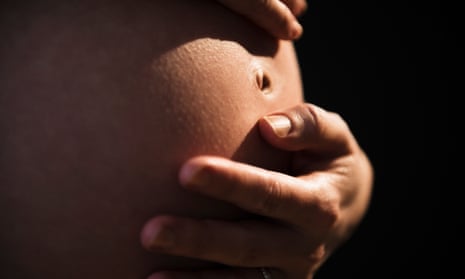 woman holding her pregnant tummy