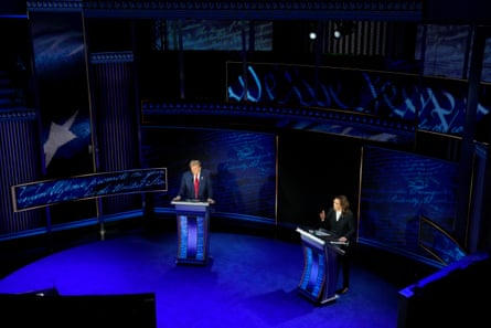 two people in suits stand behind lecterns
