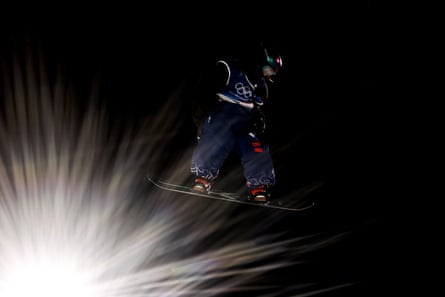 Mia Brookes jumps next to the floodlights.