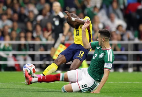 Enner Valencia has a shot blocked by Mexico's Cesar Montes