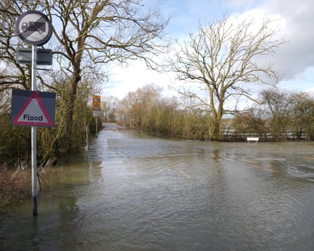 A flood warning sign on a flooded road