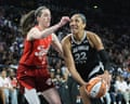 A’ja Wilson drives to the basket against Caitlin Clark during the first quarter of the Las Vegas Aces’ Game 3 playoff win over the Indiana Fever on Thursday in Las Vegas.