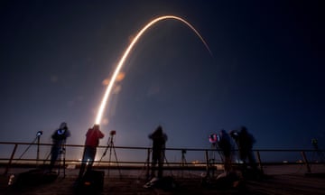 people photograph a rocket launch
