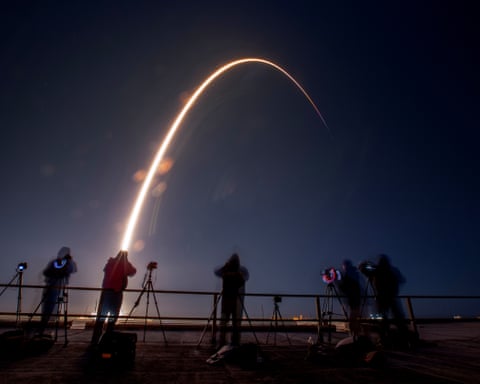 An arc of light at night as the rocket lifts off