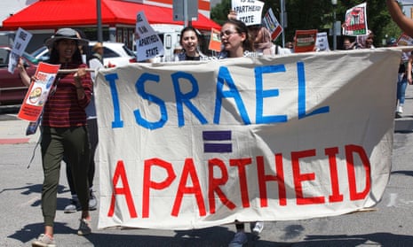 Free Palestine advocates hold a banner that equates Israel with an apartheid state while marching on North High St, Columbus, Ohio, in June 2021.