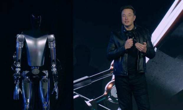 Elon Musk standing on stage next to Optimus the humanoid robot in Palo Alto, California on 30 September 2022. Photograph: Tesla/AFP/Getty Images