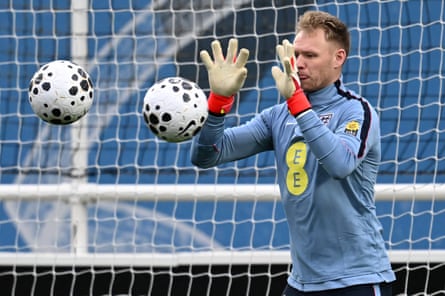 Two balls go towards England's goalkeeper Aaron Ramsdale as he takes part in a training session