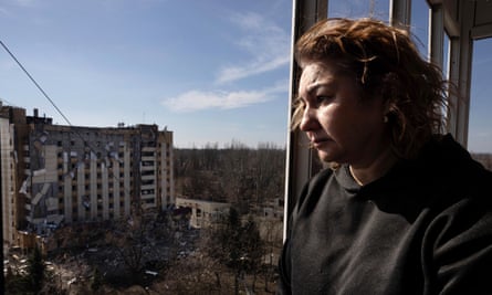 Iryna Petrochenko looks out from her damaged apartment in Kryvyi Rih, Ukraine, after a Russian missile attack killed one and wounded nine on 12 March 2025.