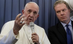 Pope Francis speaks to journalists on the plane from Ireland flanked by Vatican spokesman Greg Burke.