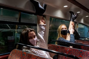 Girls with legs in the air. Night bus at 10pm first Friday of 10pm curfew when pubs closed