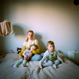 Tetiana, Solomia and Aleksij, Poland, 2022, by Michal Chelbin From the series Home from Home. Tetiana, 30, Solomia, four, and Aleksij, two, arrived from the Ivano-Frankivsk region in western Ukraine and are hosted by Mateusz, his wife Maria and their one year old son, Teodor. Tetiana said: ‘We left on 25 February, so the kids don’t know that there is war in Ukraine. My husband’s brother told me he was going to Poland, taking his kids to their mother. My husband, who works in Poland, said if I didn’t come here, he will go back to Ukraine and fight. It was an ultimatum’