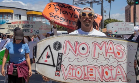 Protesters hold surfboards in demonstration against deaths of missing men
