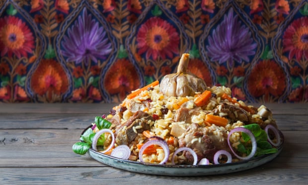 Uzbek plov a rice dish prepared with lamb, stewed with fried onions, garlic and carrots rice, dried fruits, garlic and cumin.