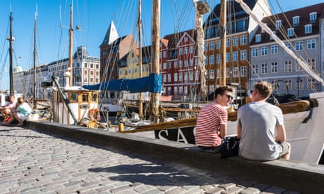 Hotels, restaurants, boats and people in the waterfront district of Nyhavn in Copenhagen