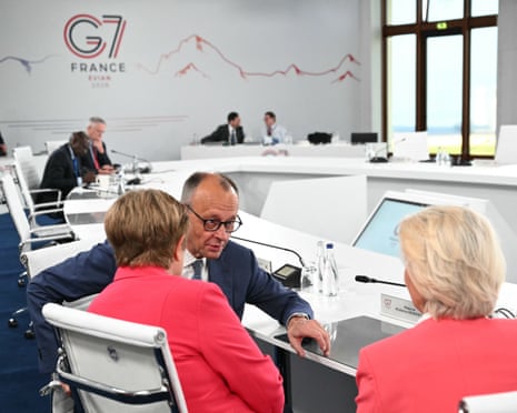 European Commission president Ursula von der Leyen (R), IMF managing director Kristalina Georgieva (L) and Germany's chancellor Friedrich Merz speak during the G7 summit, in Evian, eastern France.