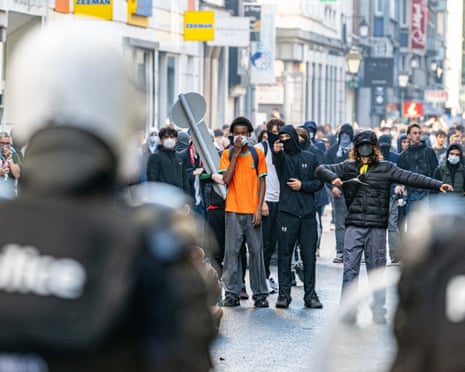 Youths confront riot police as students gather outside several schools in Liège during a protest against education reforms and budget cuts.