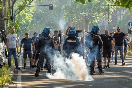 Fans clash outside the stadium as the police look on before Torino v Juventus