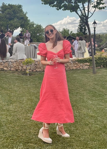 Chloe Moffat posing for a photo holding a glass of wine