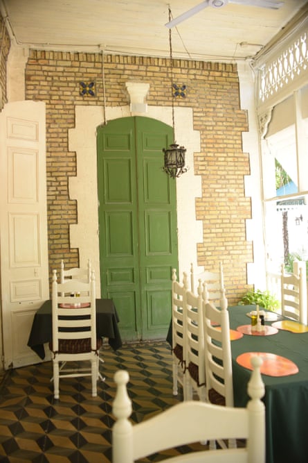 An eating area of the hotel shows high ceilings and characterful doors.