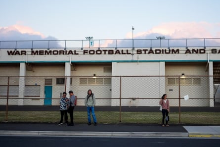 People waits at War Memorial Stadium for buses to take them across the island to their workplaces, on 9 July 2024, in Wailuku, Hawaii.