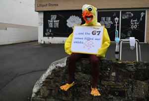A local resident dressed as a chick protests against the G7 summit in St Ives