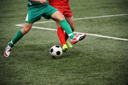 Close-up of two young footballers duelling for possession