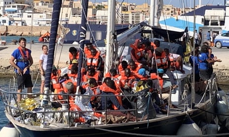 A boat arrives in Lampedusa, Sicily, with refugees rescued off the coast of Libya