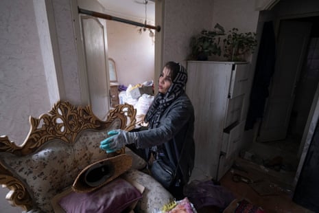 An Iranian woman in her apartment damaged during the US-Israeli strikes in Tehran