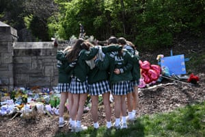 Students from the nearby Harpeth Hall School pray while visiting a memorial at the school entrance after a deadly shooting at the Covenant School in Nashville, US