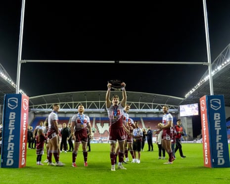 Wigan Warriors' Ethan Havard celebrates with the league leadersâ shield after the win over Catalan Dragons.