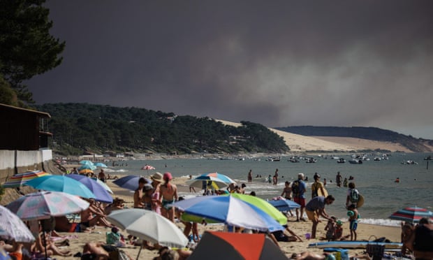 A cloud of black smoke rises near the Pyla Dune in the Arcachon Basin in southwestern France