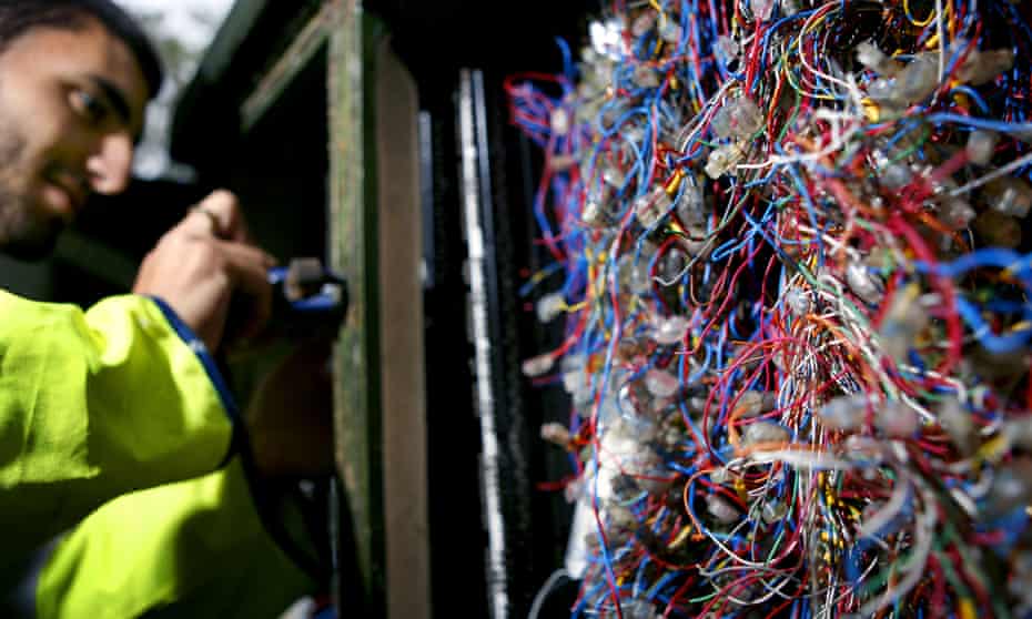 A BT engineer fixes phone lines in London.