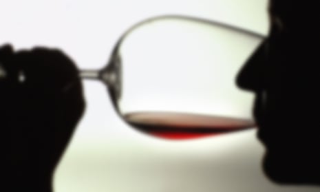 Silhouette of a person drinking red wine